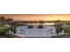 Stunning sunset view of an outdoor lounge area with lake views and beautiful green landscape surroundings at 4050 Nw 48Th Terrace Rd, Ocala, FL 34482