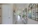 Inviting entryway with neutral walls, tile flooring, and decorative mirrors and console table at 4050 Nw 48Th Terrace Rd, Ocala, FL 34482