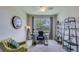 Home office featuring a large window, desk, comfortable seating, and shelving units at 4050 Nw 48Th Terrace Rd, Ocala, FL 34482