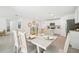 Elegant dining room featuring a large table set for six, with views of the kitchen and living areas at 4691 Sw 88Th Ln, Ocala, FL 34476