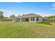 A sprawling green backyard provides ample space for recreation and relaxation at 5144 Ne 9Th St, Ocala, FL 34470