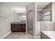 Bright bathroom featuring a granite vanity, glass shower, and tiled floors at 5144 Ne 9Th St, Ocala, FL 34470