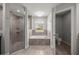 Bright bathroom with a glass enclosed shower, garden tub, and separate toilet room at 5144 Ne 9Th St, Ocala, FL 34470