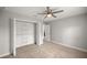 Bedroom showcasing closet space, neutral carpet, and a modern ceiling fan at 5144 Ne 9Th St, Ocala, FL 34470