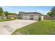 Well-maintained home featuring a spacious driveway and manicured lawn at 5144 Ne 9Th St, Ocala, FL 34470