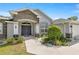 Inviting front entrance with a stone archway, decorative landscaping, and a paved walkway at 5144 Ne 9Th St, Ocala, FL 34470