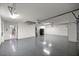 Spacious garage with epoxy flooring, ample lighting, and neutral walls at 5144 Ne 9Th St, Ocala, FL 34470