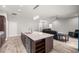 Open-concept kitchen with island seating, stainless appliances, and seamless access to the living area at 5144 Ne 9Th St, Ocala, FL 34470