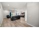 Open-concept living room featuring wood floors and a view of the kitchen at 5144 Ne 9Th St, Ocala, FL 34470