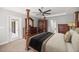 Angle view of a spacious main bedroom featuring an exterior door and dark wood furnishings at 5144 Ne 9Th St, Ocala, FL 34470