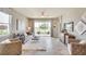 Open concept living room with neutral tones, large windows, and a sliding glass door leading to the backyard at 5339 Nw 46Th Lane Rd, Ocala, FL 34482