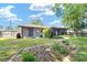 Spacious backyard with a well-maintained lawn, landscaping, and a home exterior at 5720 Se 22Nd Pl, Ocala, FL 34480
