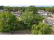 Backyard features mature trees providing shade and a sense of privacy, with homes visible in the distance at 5720 Se 22Nd Pl, Ocala, FL 34480