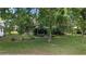 The property has a large backyard, mature trees, and a screened in back patio at 5720 Se 22Nd Pl, Ocala, FL 34480