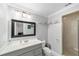Modern bathroom with updated vanity, grey cabinets, and a glass-enclosed shower at 5720 Se 22Nd Pl, Ocala, FL 34480
