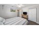Comfortable bedroom featuring a striped bedspread, ceiling fan, and closet for ample storage at 5720 Se 22Nd Pl, Ocala, FL 34480
