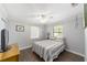 Cozy bedroom with vinyl flooring, ceiling fan, and a comfortable bed at 5720 Se 22Nd Pl, Ocala, FL 34480