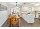 Dining room with hardwood floors, modern lighting, and easy access to the kitchen at 5720 Se 22Nd Pl, Ocala, FL 34480