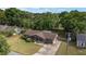 Charming single-story home featuring a well-maintained lawn, mature trees, and a long private driveway at 5720 Se 22Nd Pl, Ocala, FL 34480