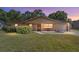 Charming brick home featuring a well-maintained lawn and inviting front porch at 5720 Se 22Nd Pl, Ocala, FL 34480