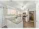 Well-lit kitchen features stainless steel appliances, white cabinets, granite counters, and subway tile backsplash at 5720 Se 22Nd Pl, Ocala, FL 34480