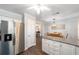 Kitchen island with granite countertops and stainless steel refrigerator nearby at 5720 Se 22Nd Pl, Ocala, FL 34480
