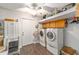 Functional laundry room with washer, dryer, storage cabinets, and a ceiling fan at 5720 Se 22Nd Pl, Ocala, FL 34480