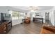 Bright living room with hardwood floors, comfortable seating, and a view of the yard at 5720 Se 22Nd Pl, Ocala, FL 34480