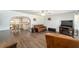 Spacious living room with hardwood floors, comfortable seating, and natural light at 5720 Se 22Nd Pl, Ocala, FL 34480