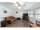 Cozy living room featuring hardwood floors, comfortable seating, and a ceiling fan at 5720 Se 22Nd Pl, Ocala, FL 34480