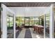 Relaxing screened porch with outdoor seating, table, and view of the backyard at 5720 Se 22Nd Pl, Ocala, FL 34480