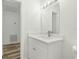 Bathroom featuring a vanity and sink with modern light fixture and wood-look flooring at 6840 Sw 198Th Ave, Dunnellon, FL 34431