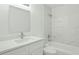 Bathroom features a shower-tub combo, white subway tile, and white vanity with ample lighting at 6840 Sw 198Th Ave, Dunnellon, FL 34431