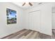 Bedroom with new LVP flooring, ceiling fan, and window offering natural light at 6840 Sw 198Th Ave, Dunnellon, FL 34431