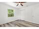 Neutral bedroom showcases wood-look flooring, fresh paint, closet, and ceiling fan at 6840 Sw 198Th Ave, Dunnellon, FL 34431