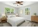 Cozy bedroom featuring a comfortable bed, soft lighting, and natural views through the windows at 6840 Sw 198Th Ave, Dunnellon, FL 34431
