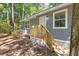 Exterior of the home featuring wood siding, white trim and a new wooden staircase leading up to the front door at 6840 Sw 198Th Ave, Dunnellon, FL 34431