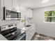 Modern kitchen with stainless steel appliances, sleek countertops, and natural light at 6840 Sw 198Th Ave, Dunnellon, FL 34431
