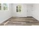 Bright room with modern floors, a view of the outdoors, and a pristine white door at 6840 Sw 198Th Ave, Dunnellon, FL 34431