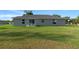 Exterior view featuring a spacious lawn and outdoor patio set, perfect for entertaining at 7886 Sw 103Rd Loop, Ocala, FL 34476