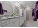 Bright bathroom with double vanity, granite countertops, and tiled shower and floors at 7886 Sw 103Rd Loop, Ocala, FL 34476