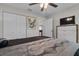 Comfortable bedroom featuring neutral tones, a ceiling fan, and dual closets at 7886 Sw 103Rd Loop, Ocala, FL 34476