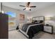 Cozy bedroom featuring a ceiling fan, a window overlooking the yard and neutral tones at 7886 Sw 103Rd Loop, Ocala, FL 34476