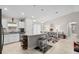Open-concept kitchen with island seating, stainless appliances, and adjacent dining area with ample natural light at 7886 Sw 103Rd Loop, Ocala, FL 34476