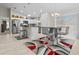 Well-lit kitchen features stainless appliances, island seating, and adjacent dining area with barstool seating at 7886 Sw 103Rd Loop, Ocala, FL 34476