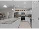 Spacious kitchen featuring stainless steel appliances, granite countertops, and an island at 7886 Sw 103Rd Loop, Ocala, FL 34476