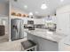 Bright kitchen with stainless steel appliances, white cabinets, and granite countertops with island at 7886 Sw 103Rd Loop, Ocala, FL 34476