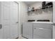 Practical laundry room with washer, dryer, shelving, and ample space for sorting and folding at 7886 Sw 103Rd Loop, Ocala, FL 34476