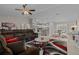 Comfortable living room features neutral walls, a plush sectional sofa, ceiling fan, and open floor plan at 7886 Sw 103Rd Loop, Ocala, FL 34476