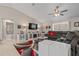 Comfortable living room features neutral walls, a plush sectional sofa, ceiling fan, and adjacent bath at 7886 Sw 103Rd Loop, Ocala, FL 34476